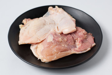 Fresh raw chicken meat on black dish