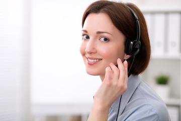  Young beautiful business woman in headset. Call center.