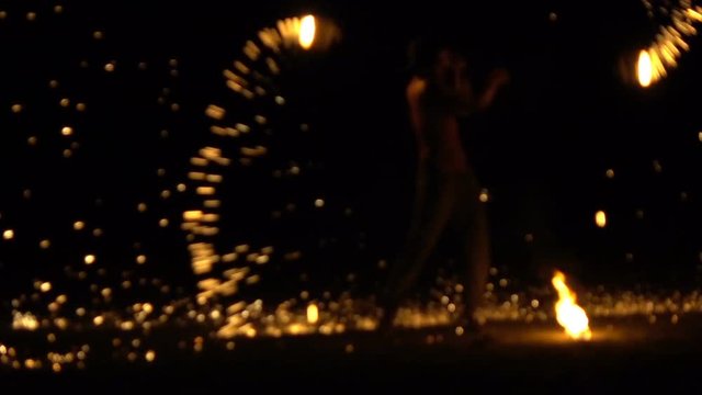 Man playing with fire during show at night, super slow motion 240fps 
