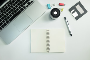 Office desk with notebook, diskette  paper clips and pen. Top vi