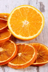 Dried and fresh orange on old wooden background