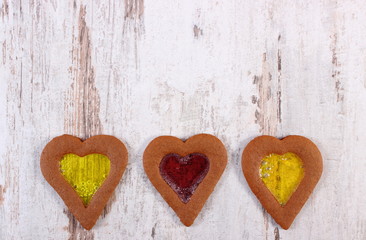 Stained glass gingerbread on old wooden background, christmas time