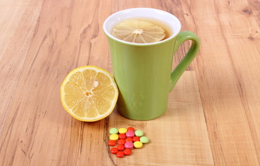 Pills and hot tea with lemon for colds, treatment of flu and runny