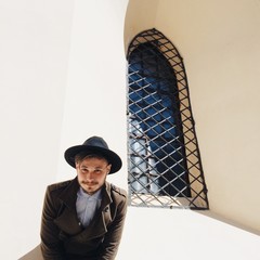 bearded man in hat and coat on city street. autumn fashion concept