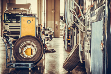 bus and truck waiting for service in the garage, vintage photo a