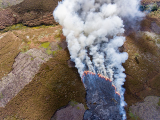 From above: thick white smoke from burning heather. Derbyshire