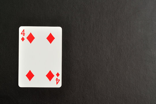 Playing card. Four of diamond isolated on a black background