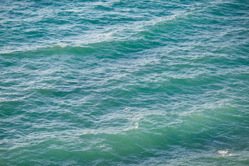 Turquoise clear water and small waves