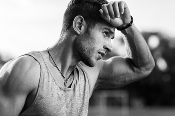 Black-and-white portrait of tired muscular male