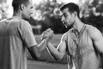 Black and white portrait of handsome men with arm wrestling