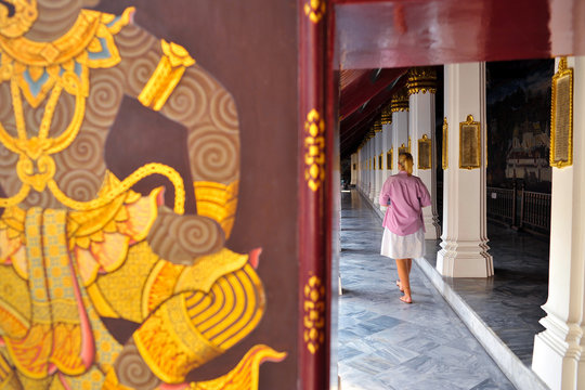one female tourist walking in Thai temple