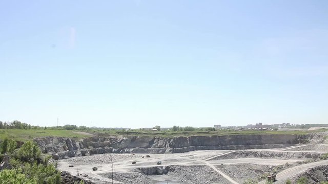 mining quarry with moving industrial cars