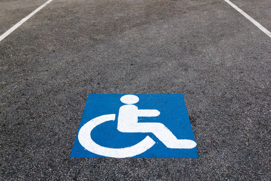 handicapped parking sign paint onto asphalt parking