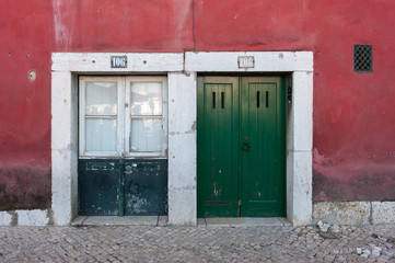 Two colorful wooden doors to a building in Lisbon