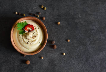 Creamy sauce with garlic, eggs and pepper on a black background. - obrazy, fototapety, plakaty