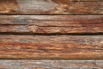 A fragment of a wall made of wooden logs