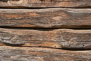 A fragment of a wall made of wooden logs