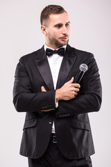 The Showman interviewer. Young elegant man against white background.Showman concept.