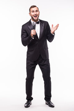 The Showman interviewer with emotions. Young elegant man holding microphone against white background.Showman concept.