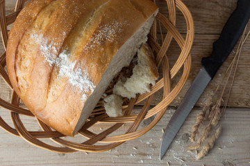 fresh baked bread and ears on wooden table