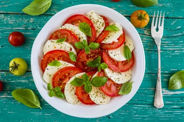Foto op Plexiglas Delicious caprese salad with ripe tomatoes and mozzarella cheese with fresh basil leaves. Italian food.  © iMarzi