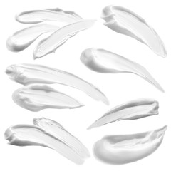 Beauty cream samples on white background.