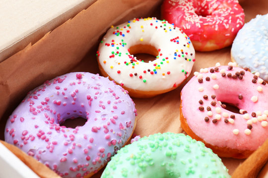 Delicious donuts in box, closeup