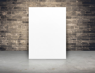 Blank white paper poster at grunge brick wall and concrete floor