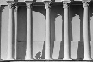 Shadow girl among columns