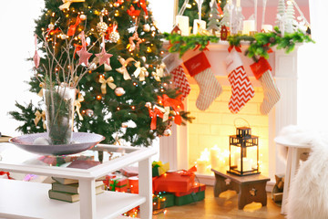 Fototapeta na wymiar Fireplace in beautiful living room decorated for Christmas