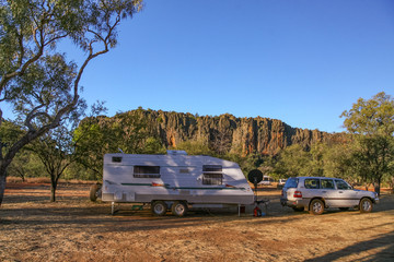 Caravan and four wheel drive vehicle in camping area at Windjana Gorge
