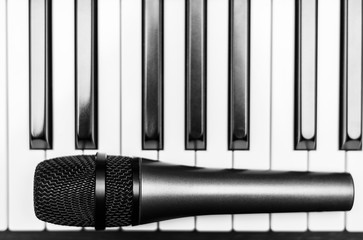 Close up microphone on piano keyboard in music studio. Music concept.