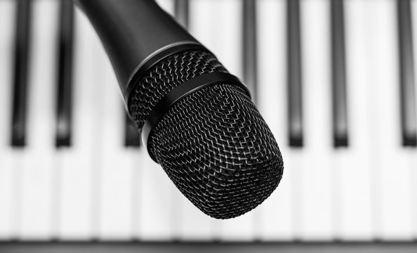Close up microphone on piano keyboard in music studio. Music concept.