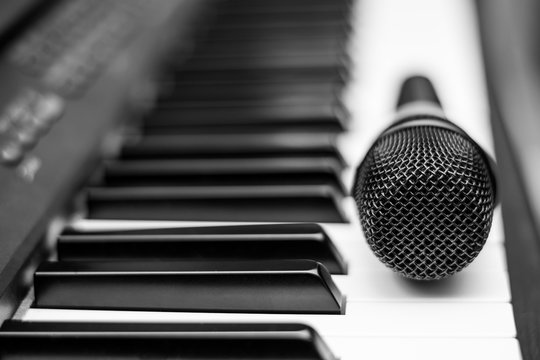 Close up microphone on piano keyboard in music studio. Music concept.