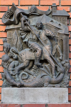 Mukachevo, Ukraine - July 21: a bas-relief on the wall closeup with the image of St. George slaying the dragon July 21, 2016 in Mukachevo, Ukraine