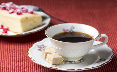 Morning Coffee and cheesecake  on red tablecloth