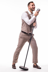 Young showman in suit singing with emotions gesture over the microphone with energy. Isolated on white background. Singer concept.