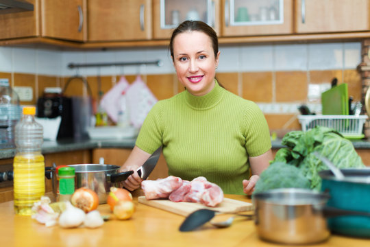 Woman Preparing Meal In Kitchen