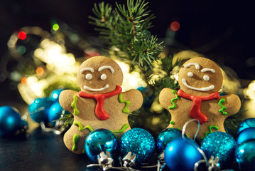 gingerbread man near Christmas tree with toys by garland