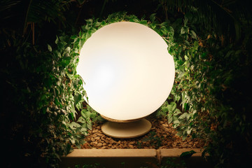 Round lantern shines in the city Park