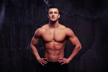 Fototapeta premium Portrait of male model showing his reliefed body