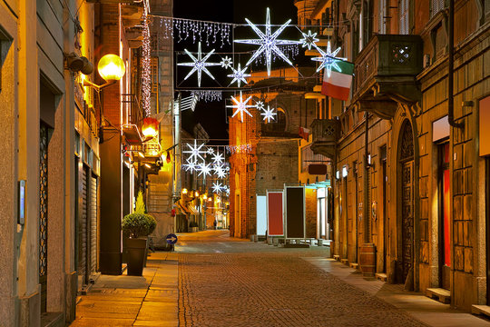 Fototapeta Central street at evening. Alba, Italy.