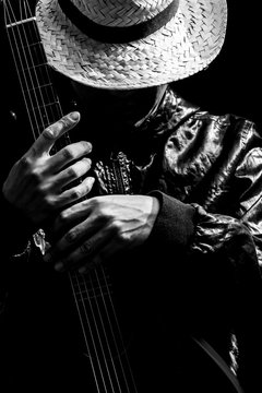 musician holding guitar, black and white filter for music background