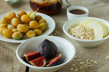 Figs, plums, oatmeal flakes with apple