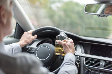 Man drinking alcohol and driving