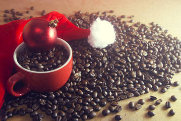 coffee in the cup with gloss ball decor and santa claus hat