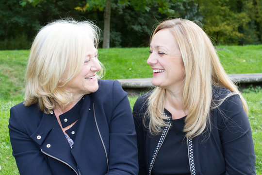 Senior Mother With Adult Daughter And Affectionately Talking