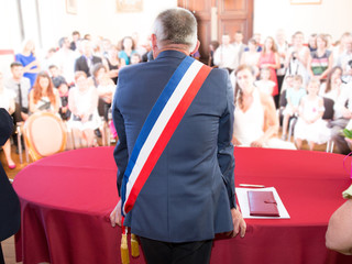 Back of French mayor with a scarf flag