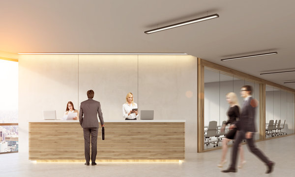 Man talking to receptionists in office