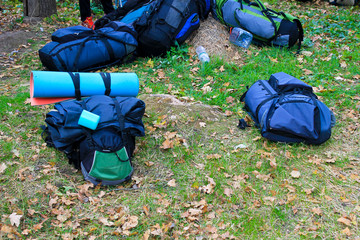 Many backpacks of hikers on a meadow